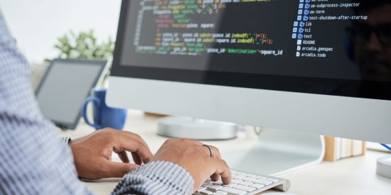 Cropped image of It specialist working on code